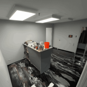 Contemporary office interior with black epoxy resin floor, offering a sleek and durable finish.